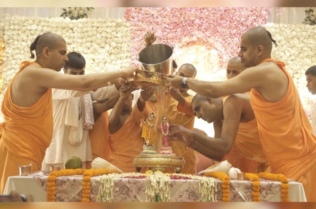 Sannyasis performing abhishek of the Deities